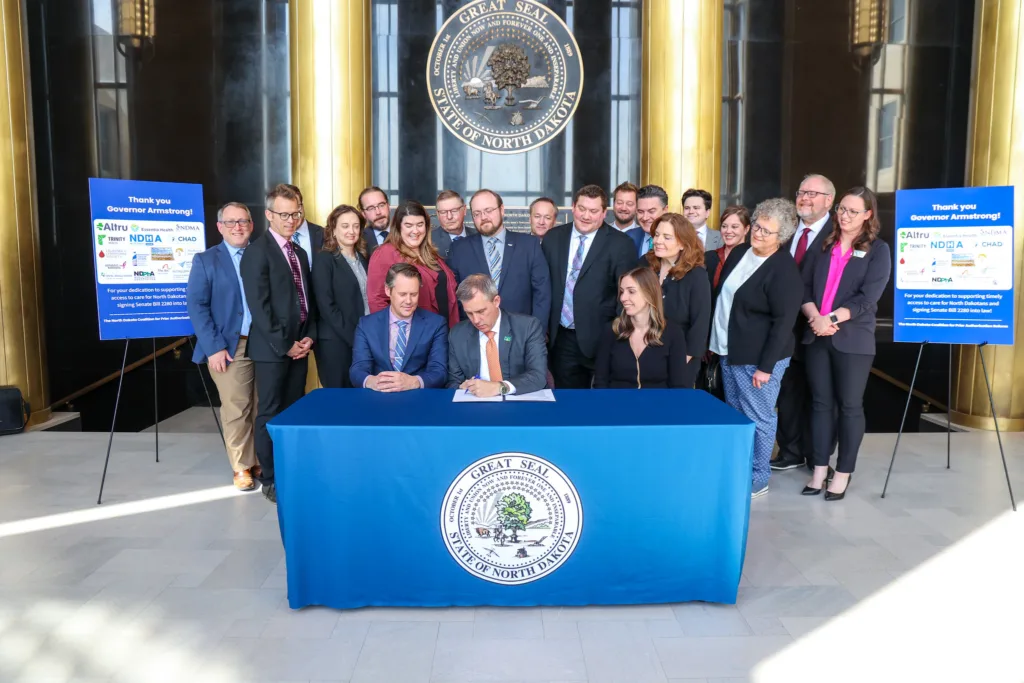 Supporters watch as North Dakota Gov. Kelly Armstrong signs a bill April 23, 2025, with reforms for health insurance prior authorization. (Photo provided by Office of the Governor)