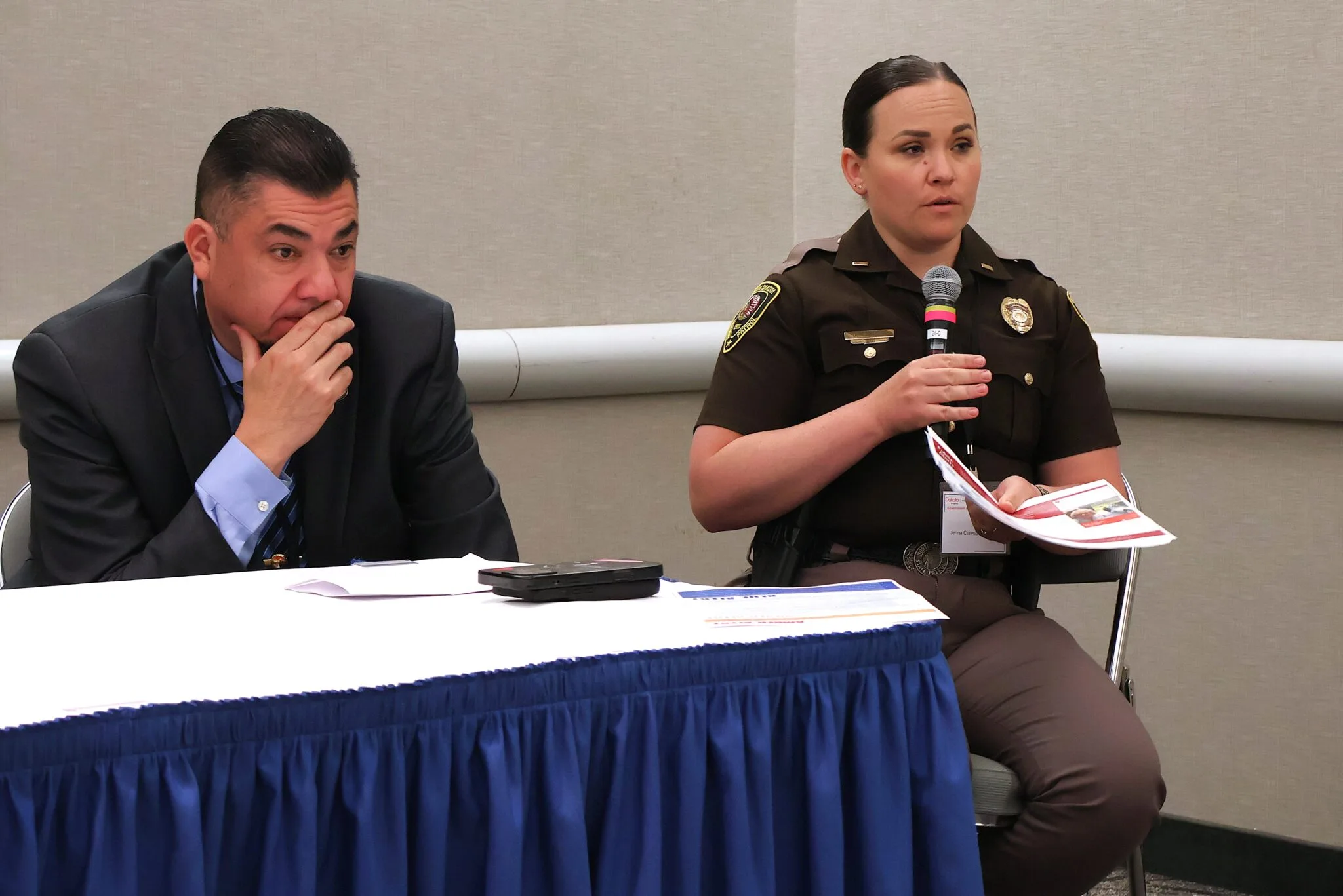 North Dakota Highway Patrol Lt. Jenna Clawson Huibregtse, right, special programs coordinator for safety and education for the department, speaks next to Phil Packineau, left, public safety administrator for the Mandan, Hidatsa and Arikara Nation, on new alerts being added to the state’s emergency system during the Government-to-Government Conference on June 5, 2025. (Michael Achterling/North Dakota Monitor)